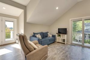 a living room with a blue couch and a tv at Young Harris Vacation Rental with Mountain Views! in Young Harris