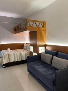 - un salon avec un canapé et un lit dans l'établissement Refugio Caminho da Praia, à Anchieta