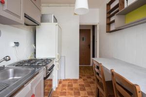 a kitchen with a sink and a stove top oven at Pokoje Wasilkowskiego in Warsaw +23 photos