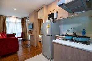 a kitchen with a refrigerator and a counter top at iCheck inn Residences Patong in Patong Beach