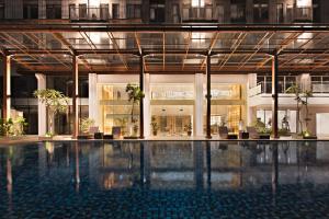 a large building with a swimming pool in the middle at Kawana Golf Residence in Cikarang