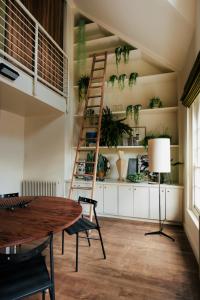 a room with a table and a ladder and plants at Stylish 1 bedroom in Covent Garden with terrace in London