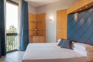 a bedroom with a large bed and a large window at Hotel Ristorante Al Mulino in Alessandria