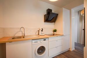 eine Küche mit einer Waschmaschine und einem Waschbecken in der Unterkunft Le Havre - Quartier des Docks au Calme - 4 Appartements Entièrement Rénovés - NOUVEAU in Le Havre