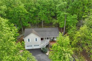 an overhead view of a white house in the woods at Big Home Game Room, Hot Tub and 17-Seat Theater in Massanutten