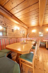 a wooden room with a wooden table and chairs at am mühlbach - einfach sein in Dorfgastein