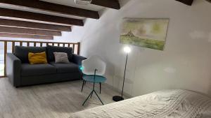 a bedroom with a couch and a table and a bed at Appartement - Résidence Le Paradou in Rayol-Canadel-sur-Mer