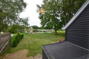 a backyard with a pond and a house at Riverfront Retreat! Water front and dog friendly! in Two Rivers