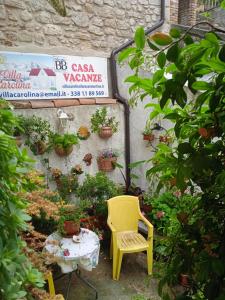 a yellow chair sitting in a garden with plants at Villa Carolina in Fara San Martino