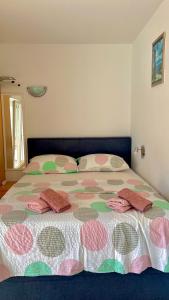 a bedroom with a large bed with pillows on it at Apartments Neven in Omiš