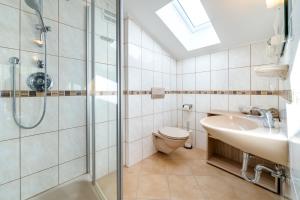 a bathroom with a shower and a toilet and a sink at am mühlbach - einfach sein in Dorfgastein