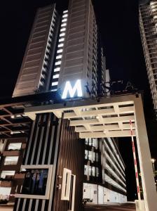 a large building with the letter m on top of it at MVISTA 3BR AirportView CozyStay in Bayan Lepas