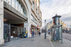 a street with people walking on a sidewalk next to buildings at Central Avenue Apartment in Budapest