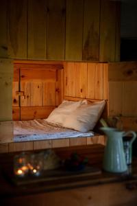 a wooden bed in a wooden walled room with a bed sidx sidx at Stony Creek Farmstead in Walton
