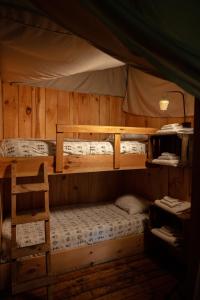 a room with three bunk beds in a cabin at Stony Creek Farmstead in Walton