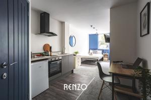 a kitchen with a desk and a table with a laptop at Vibrant 1-bed Apartment in Derby by Renzo, Central Location! in Derby