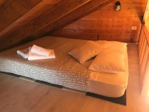 a bed in a attic with two pillows on it at Cozy Mountain Chalet in La Orotava