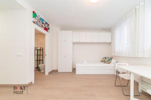 Dieses weiße Zimmer verfügt über ein Bett und einen Schreibtisch. in der Unterkunft Marqués de Vadillo1 Apartments in Madrid