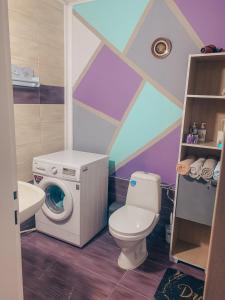 a bathroom with a toilet and a washing machine at THE CHEAPEST IN THE CITY Sagittarius in Komotini