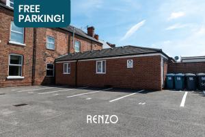 a parking lot in front of a brick building at Charming 2-bed Apartment in Nottingham by Renzo, Modern Design, Brilliant Location in Nottingham
