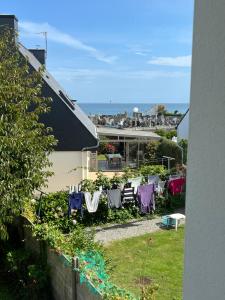 a yard with chairs and tables and a house at Brittany Beach Home Gavres - Morbihan in Porh-Guer