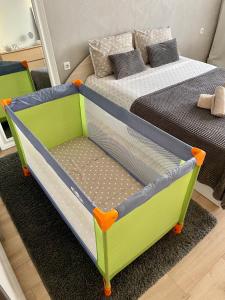 a childs bed in a room with a bed at Comfy & Stylish in Varna City