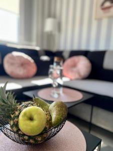 a bowl of fruit on a table in a living room at Spółdzielcza 22 Apartament Sky Line in Kłodzko