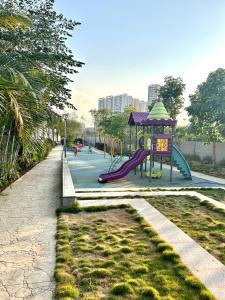 a playground in a park with a slide at BREEZE: By Aryavarta (King-sized 2 BHK apartment) in Pune