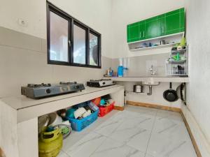 a kitchen with a counter and a sink in a room at Villa Cisarua Ananda in Brujul