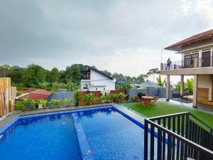 a swimming pool in the backyard of a house at Villa Cisarua Ananda in Brujul