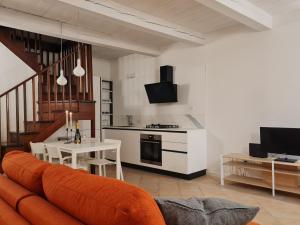 a kitchen and living room with a couch and a table at La serva padrona in Iesi