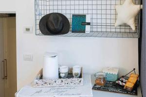 a shelf with a hat and other items on a counter at Cozy room in the heart of Como in Como