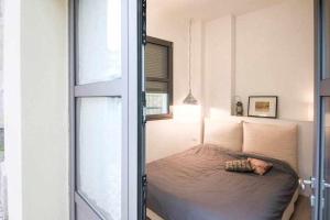a bedroom with a bed in a room with a window at Cozy room in the heart of Como in Como