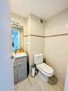 a bathroom with a toilet and a sink at Puerta al Mediterráneo in Jávea
