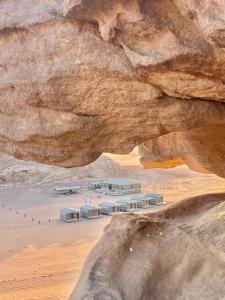 a view of a building under a rock formation at WADi RUM ALi CAMP in Wadi Rum