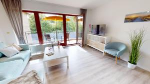 sala de estar con sofá y mesa en Mehrfamilienhaus "Ostseeblick" App 16, en Pelzerhaken