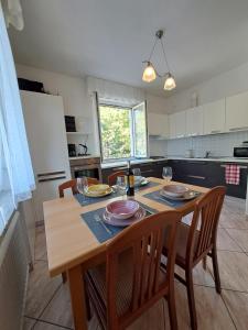 a kitchen with a wooden table with two chairs and a tableablish at Casa Alby in Levico Terme