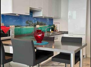 a kitchen with a table with a vase on it at Marmara Magic: Jacuzzi Getaway in Istanbul