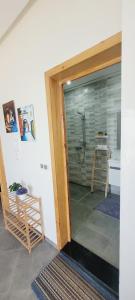 a bathroom with a shower with a glass door at Magnifique villa face à l'océan in Tiznit