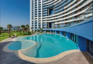 a large swimming pool in front of a large building at Marmara Magic: Jacuzzi Getaway in Istanbul