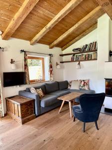 a living room with a couch and a table at Zuhaus Schernfeichten in Kitzbühel