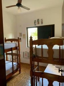 a room with two bunk beds and a window at Alma de Maré Hostel in Guarujá