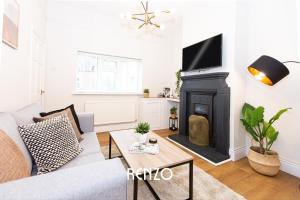 a living room with a couch and a fireplace at Charming 2-bed Home in Nottingham by Renzo, Driveway Parking! in Nottingham