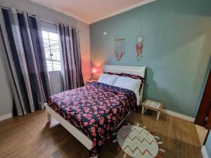 a bedroom with a bed and a clock on the wall at Casa Gómez in São Lourenço