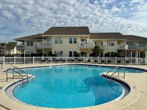 a large swimming pool in front of a house at Sandpiper Cove 8224 in Destin