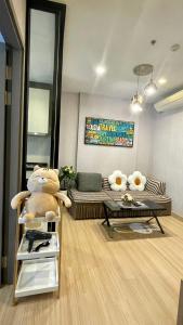 a living room with a couch and a table at The base Central Pattaya by Numam 38 in Pattaya Central