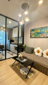 a living room with a couch and a table at The base Central Pattaya by Numam 38 in Pattaya