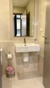 een witte badkamer met een wastafel en een spiegel bij The base Central Pattaya by Numam 38 in Pattaya