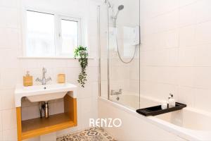 a bathroom with a sink and a shower and a tub at Inviting 3-bed Home in Nottingham by Renzo, Victorian Features, Sleeps 6! in Nottingham