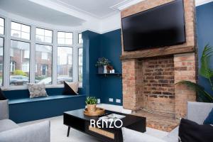 a living room with a fireplace with a flat screen tv at Inviting 3-bed Home in Nottingham by Renzo, Victorian Features, Sleeps 6! in Nottingham